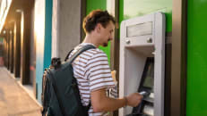 A man withdrawing money from an ATM. 