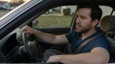 A man driving his car and worrying about car insurance after a DUI.