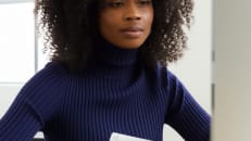 A woman wondering if the apple card is still worth it in 2025.