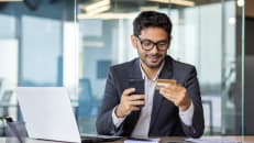 A man making strategic spending charges with his business credit card. 