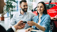 A man and a woman getting temporary car insurance for a rental car.