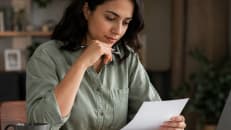 A woman learning about prepayment penalties of paying debt consolidation loans early.