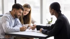 A young couple deciding between a government grant or business loan for their business.