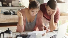 A young couple learning how to manage household debt in a high-interest economy. 