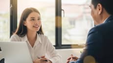 A woman talking to a financial expert about how a secured personal loan works. 