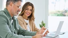 A man and woman checking up on their tax refund. 