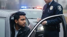 A traffic officer stopping a man that was speeding. 