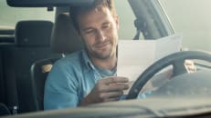 A man looking relieved because he cancelled his car insurance without penalties.