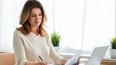 A woman following a step-by-step guide to get a mortgage. 