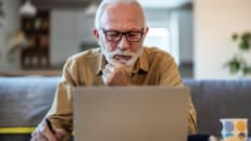A senior learning about how to withdraw money from his life insurance policy. 