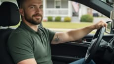 A military member driving his car with his added discounts.