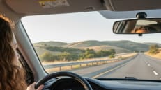 A woman driving to her new state with new car insurance rates. 