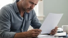 A man who is learning about how to avoid personal loan scams.