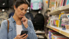 Parent considering buy now pay later at checkout while back-to-school shopping.