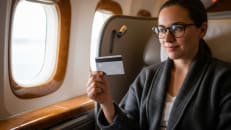 A woman flying first class with the help of her credit card. 