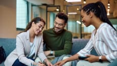 A couple learning about secured vs. unsecured debt consolidation loans. 