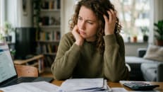 A woman stressing about her student loans being in default and how to get out of it.
