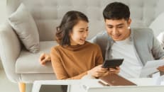 A young couple looking at their tax refund advance.