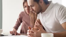 A man and woman considering if term life insurance is still worth it. 