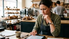 Small business owner reviewing insurance coverage in their shop.