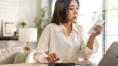 A woman learning how to handle a tax audit with a step by step guide. 