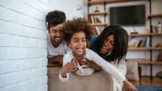young family playing in boxes