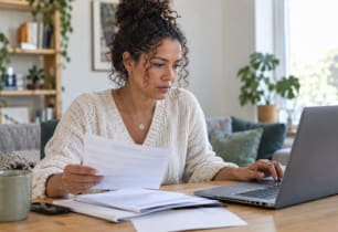 Woman reviewing her bills before applying for a debt consolidation loan.