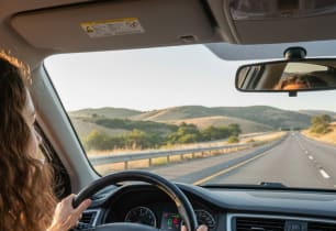 A woman driving to her new state with new car insurance rates. 