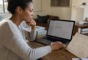 Person weighing whether to save or invest their money.