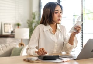 A woman learning how to handle a tax audit with a step by step guide. 