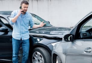 A man wondering what to do after he's been in a car accident. 