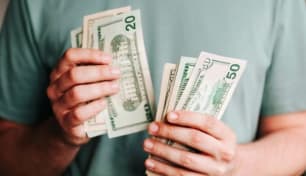 An image of a person counting money