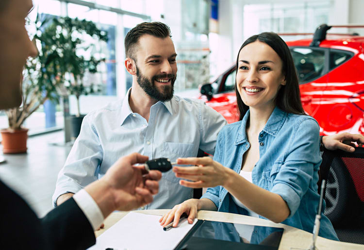 A man and a woman getting temporary car insurance for a rental car.
