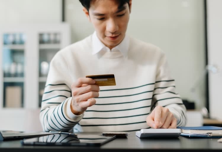 A man worried about his late payments for his credit cards. 