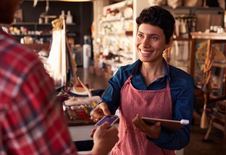 A small business owner using her POS system through her credit card company. 
