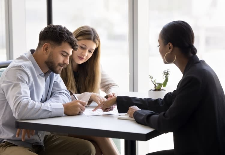 A young couple deciding between a government grant or business loan for their business.