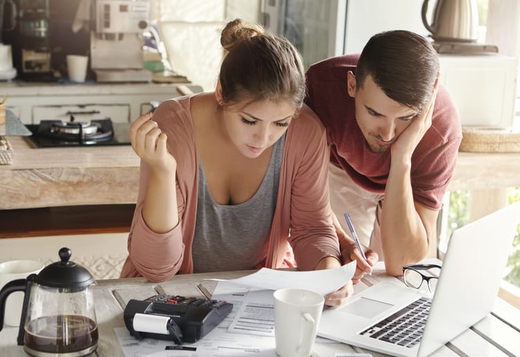 A young couple learning how to manage household debt in a high-interest economy. 