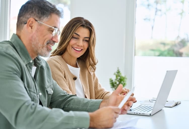 A man and woman checking up on their tax refund. 