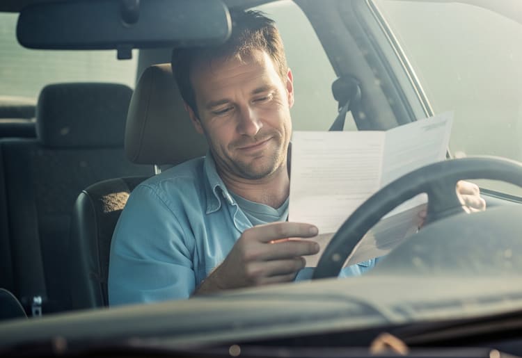 A man looking relieved because he cancelled his car insurance without penalties.