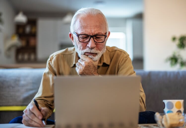 A senior learning about how to withdraw money from his life insurance policy. 