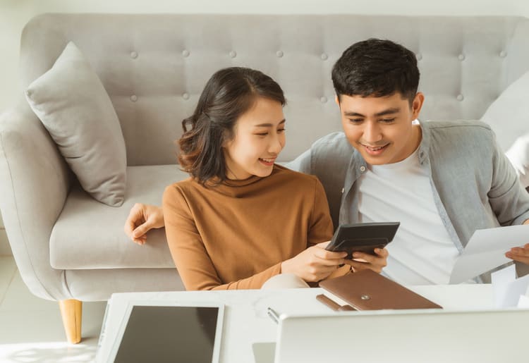 A young couple looking at their tax refund advance.
