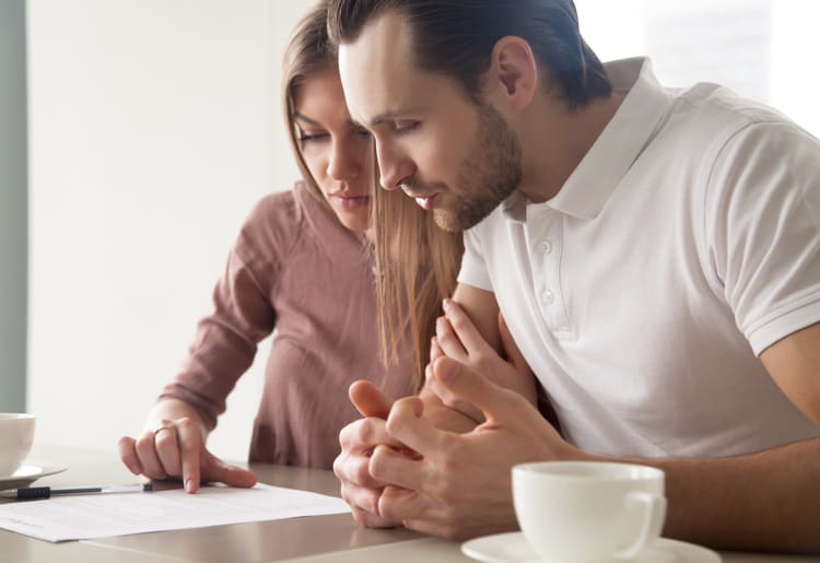 A man and woman considering if term life insurance is still worth it. 