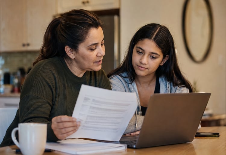 Parent and student reviewing student loan and financial aid options.