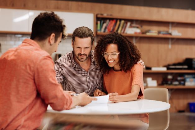 couple at a table with a broker