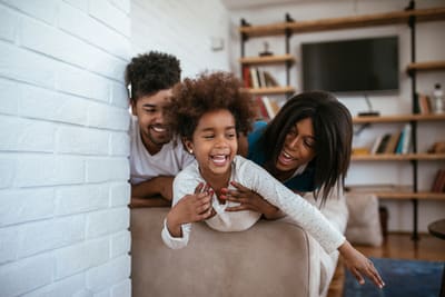 young family playing in boxes